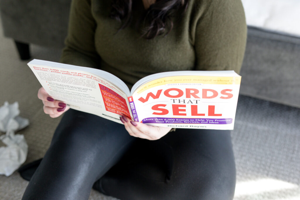 reading the book "words that sell" to write better pin titles and descriptions
