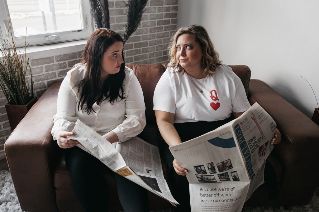 two women reading a newspaper