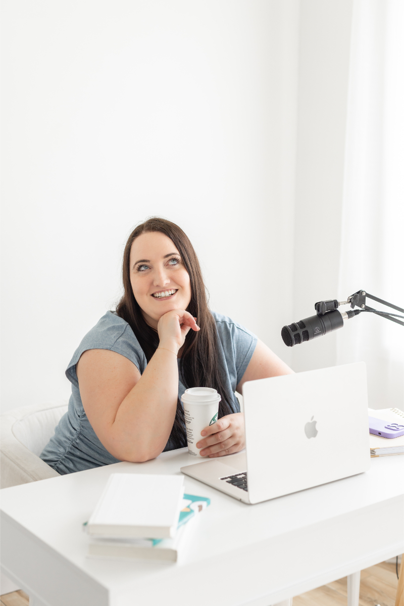 Kara sits at desk to record podcast episode and write blog posts.