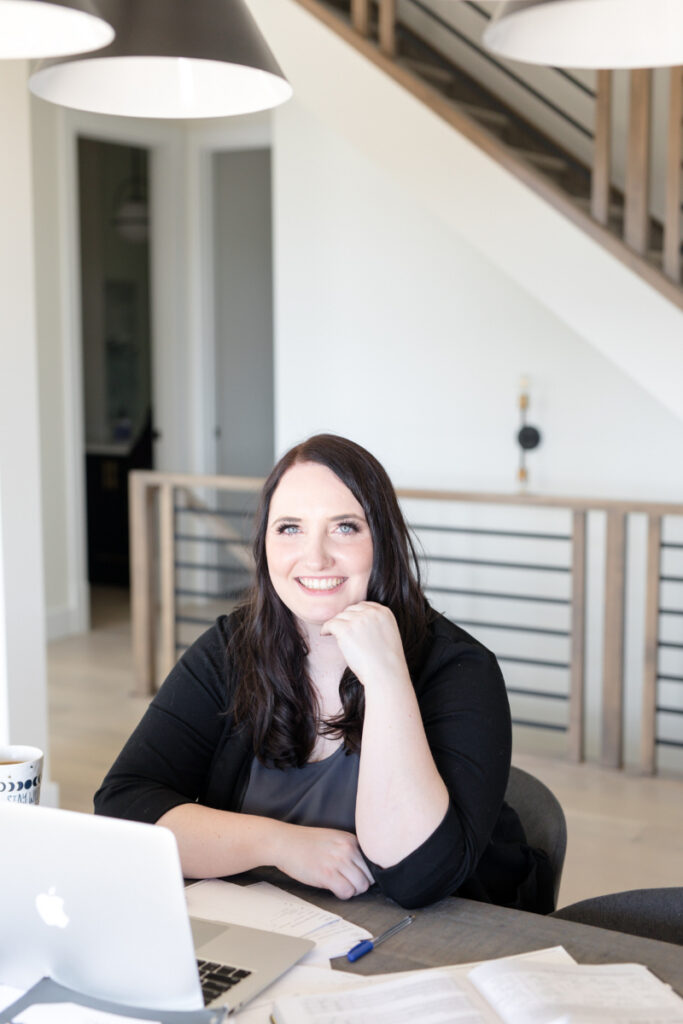 Kara sitting at her laptop creating an email opt-in for her blog readers