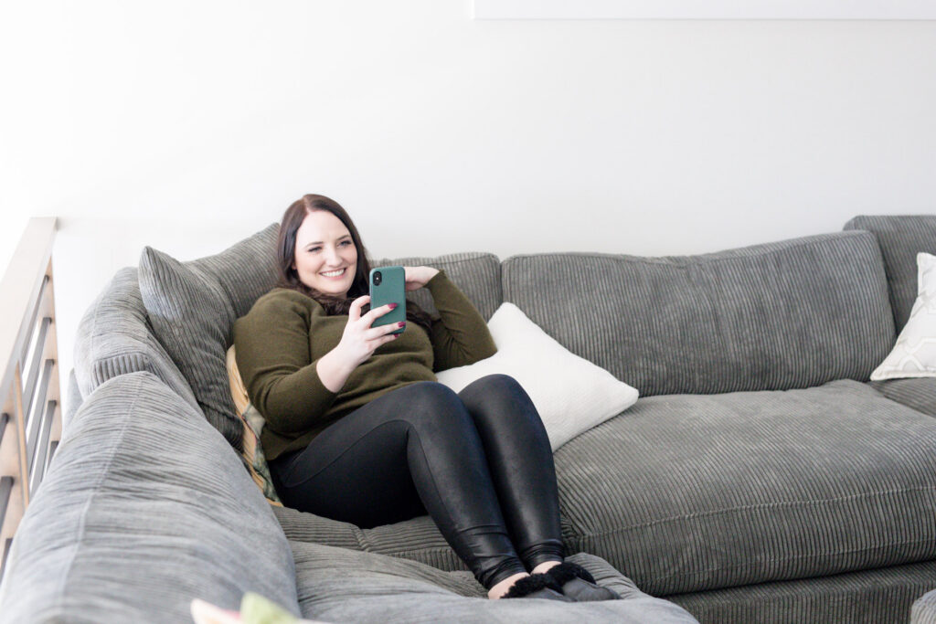 Kara sitting on coach face-timing friend about fast vs slow marketing