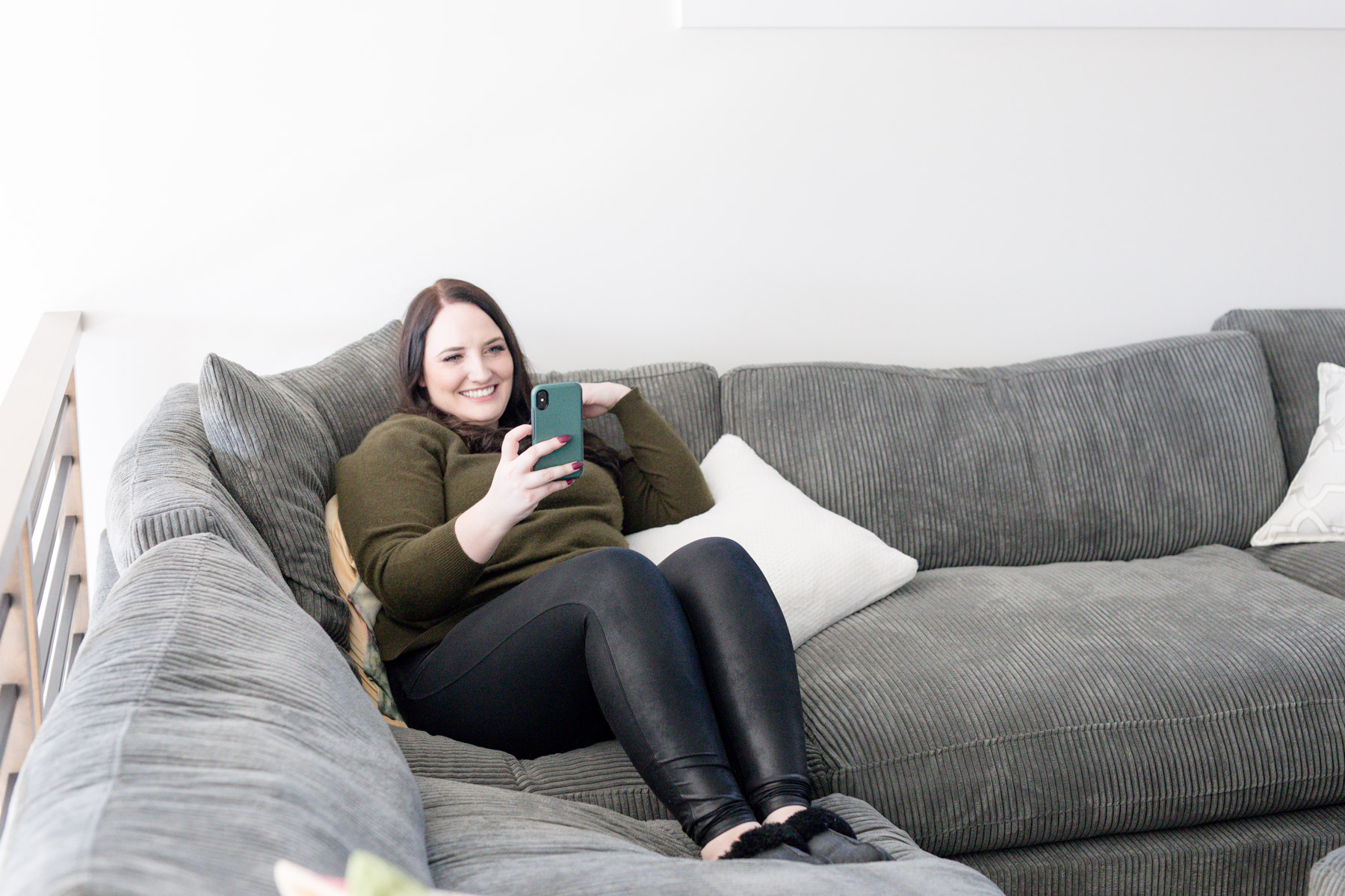 Kara sitting on coach face-timing friend about fast vs slow marketing