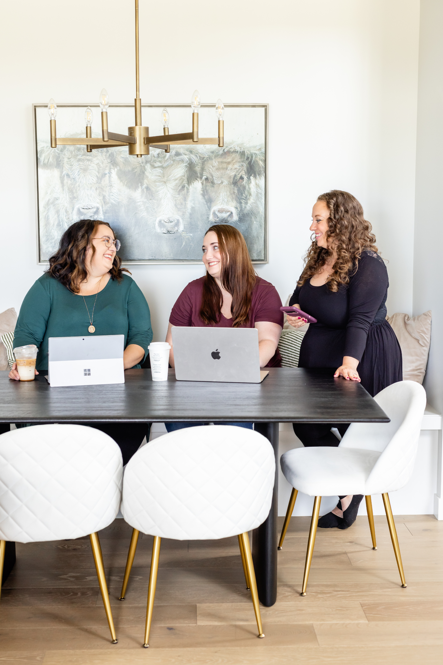 three women sitting at a table talking about the types of hires in your business