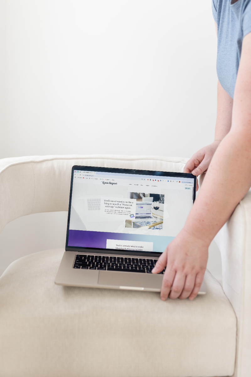 a blog writer puts down laptop on chair with blog open that has the ultimate guide to updating blog posts for SEO