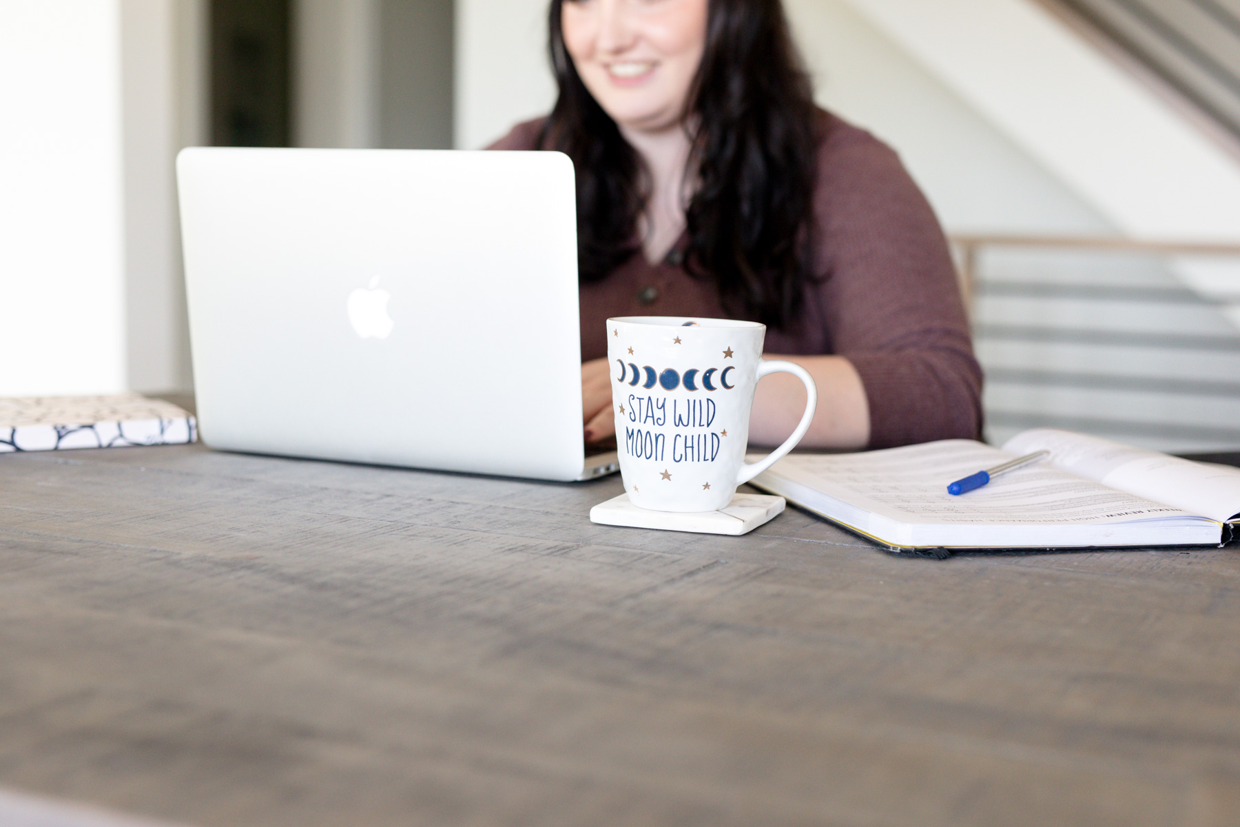 Kara Duncan sitting at her desk writing a blog about how to start a blog in Squarespace in 2026
