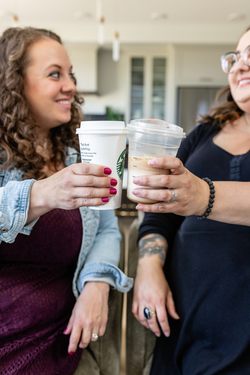 two business owners holding coffees and funmaxxing